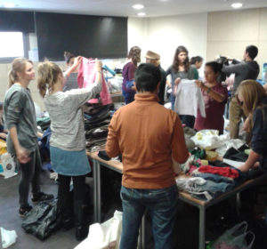 MFR volunteers sort through clothes donations for refugees 